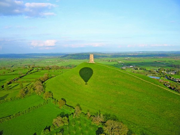 Picture of a hot air balloon shadow over a Tor