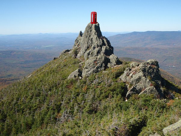 Picture of a red telephone box on the top of a mountain